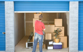 Man storing items in a storage unit